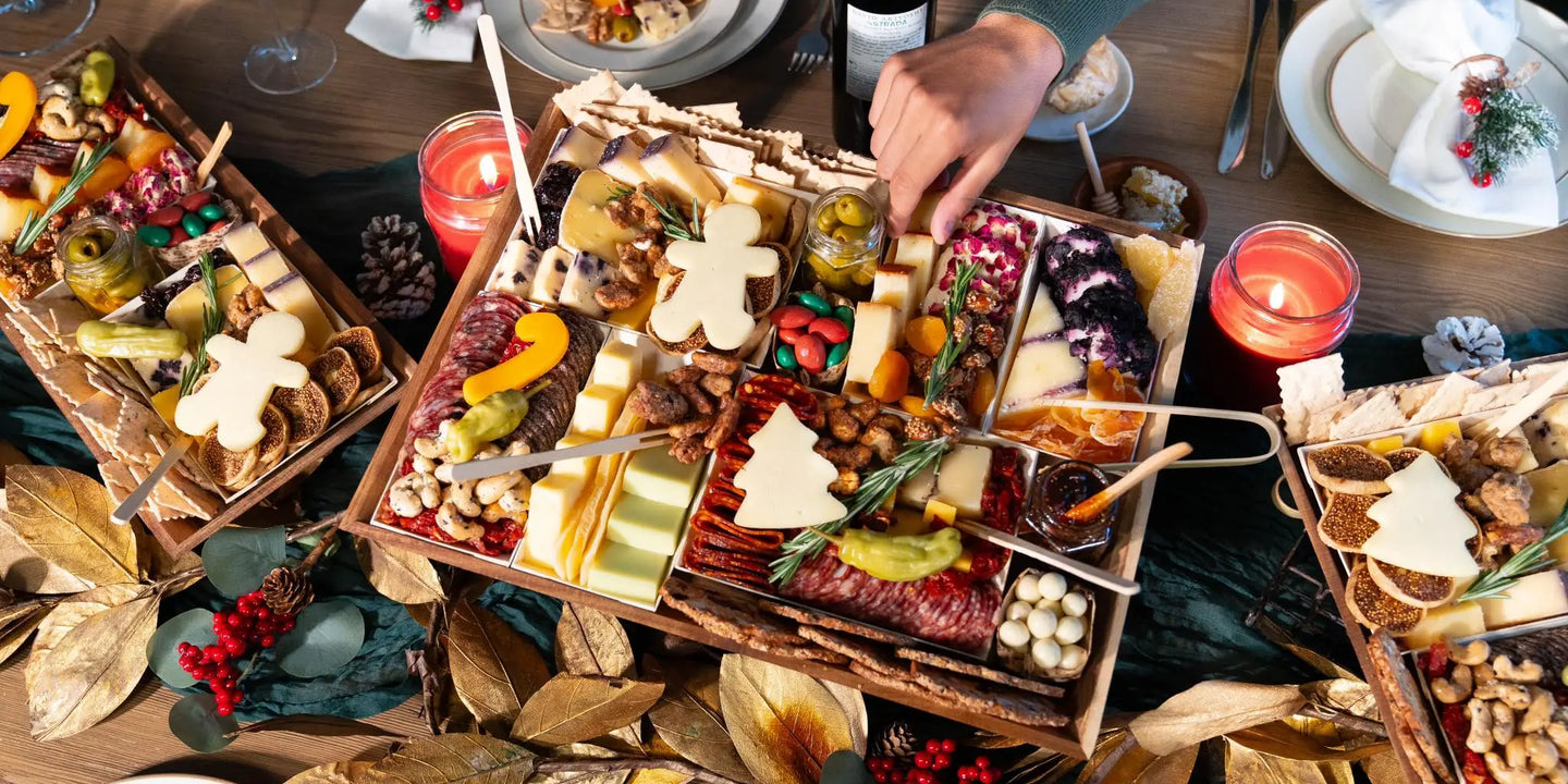 Christmas party charcuterie board with festive tree and gingerbread-shaped cheeses, meats, nuts, and holiday garnishes on a decorated table