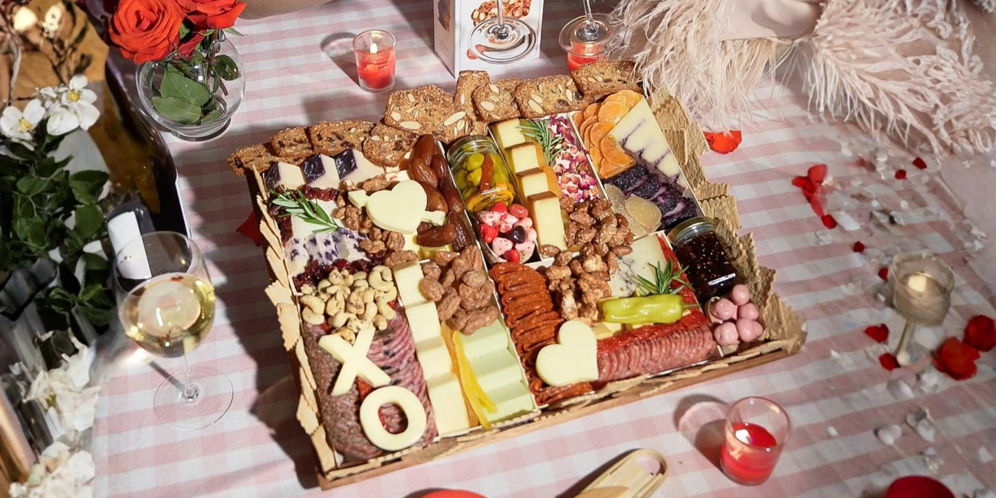 Premium charcuterie board meats showcased in an elegant picnic-style setup with cured meats, specialty cheeses, preserves, and wine.