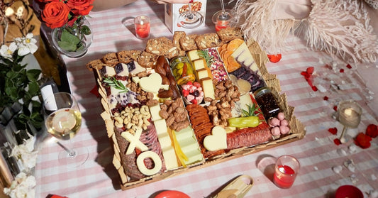 Premium charcuterie board meats showcased in an elegant picnic-style setup with cured meats, specialty cheeses, preserves, and wine.