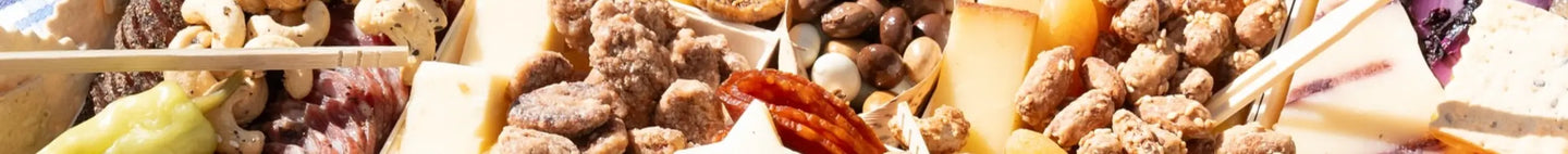 Premade charcuterie board with assorted cheeses, cured meats, candied nuts, and dried fruit.