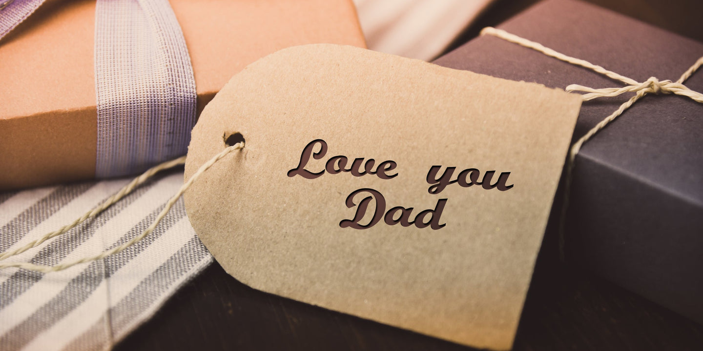 Father's Day gifts with a striped tie and a kraft tag reading "Love you Dad."