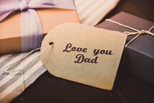 Father's Day gifts with a striped tie and a kraft tag reading "Love you Dad."