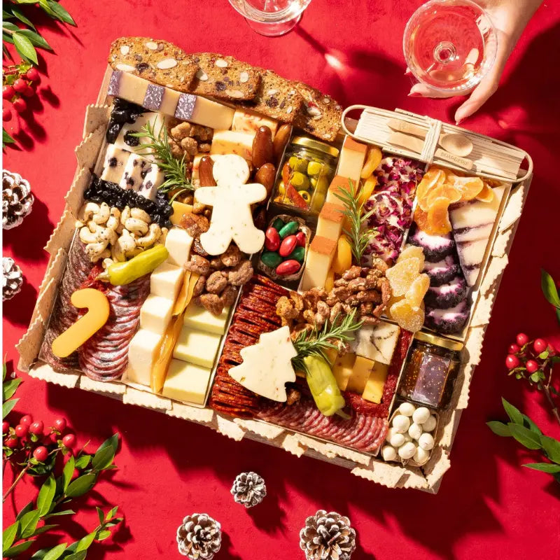 Thanksgiving charcuterie board with Oprah's favorite thing award badge, featuring leaf-shaped cheese cutouts, cured meats, nuts, pickled vegetables, and autumn garnishes on green background.
