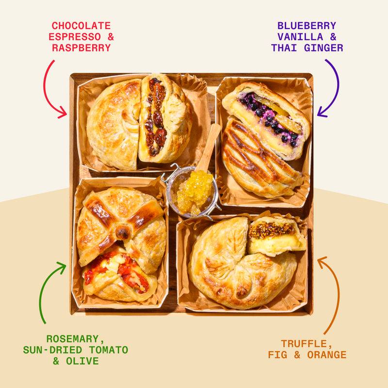 Baked brie pastry bundle featuring four flavors—chocolate espresso raspberry, blueberry vanilla Thai ginger, rosemary sun-dried tomato olive, and truffle fig orange with apricot jam center.