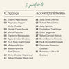 A recipe-style ingredients list for the Boarderie All Cheese Thanksgiving Board on a light beige background, with the heading 'Ingredientes' and two columns titled 'Cheeses' and 'Accompaniments' listing food items by number.