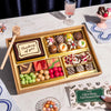 Assorted sympathy dessert box with a card on a marble table.