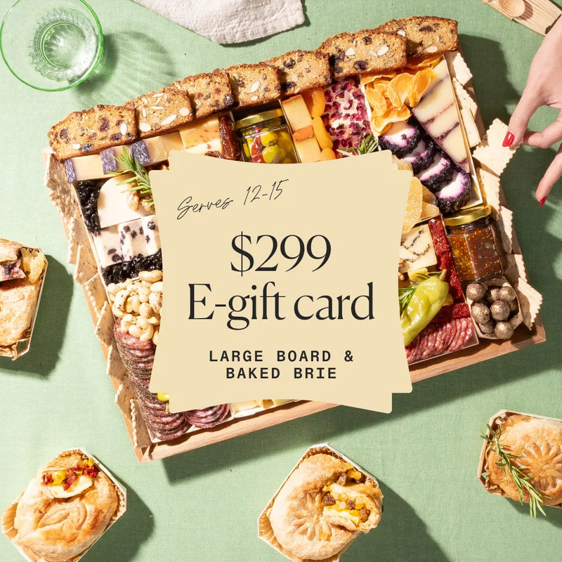 Large charcuterie board with baked brie and assorted snacks, featuring a $299 e-gift card offer.