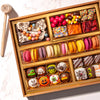 Overhead view of the Boarderie Halloween Medium Dessert Board with 30-plus gourmet treats, artisan French macarons, hand-decorated monster truffles, candy corn, brownies, and a chocolate smash box with a wooden mallet.