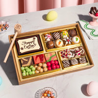 Small Easter dessert board featuring decorated chocolate truffles, a 