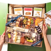 Charcuterie board meat and cheese featuring assorted cured meats, cheeses, nuts, fruits, and crackers in a premium gift box.