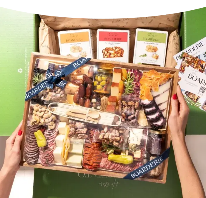 Charcuterie board meat and cheese featuring assorted cured meats, cheeses, nuts, fruits, and crackers in a premium gift box.