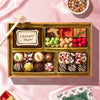 Assorted chocolates in a box on a pink fabric background