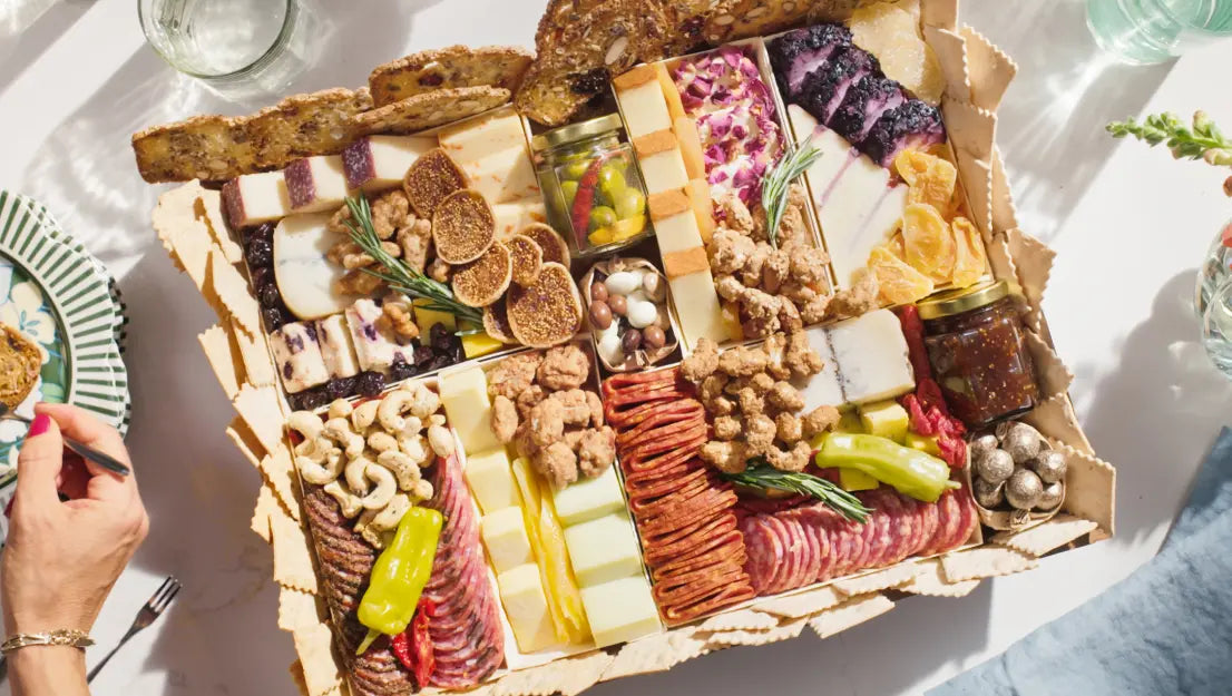 Thanksgiving charcuterie board with assorted cheeses, meats, nuts, dried fruits, and crackers arranged beautifully for serving