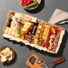 truffle charcuterie board gift featuring cheeses, crackers, nuts, dried fruits, meats, & a bottle of truffle hot sauce