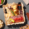 A truffle charcuterie board gift featuring assorted cheeses, cured meats, crackers, nuts, & truffle hot sauce