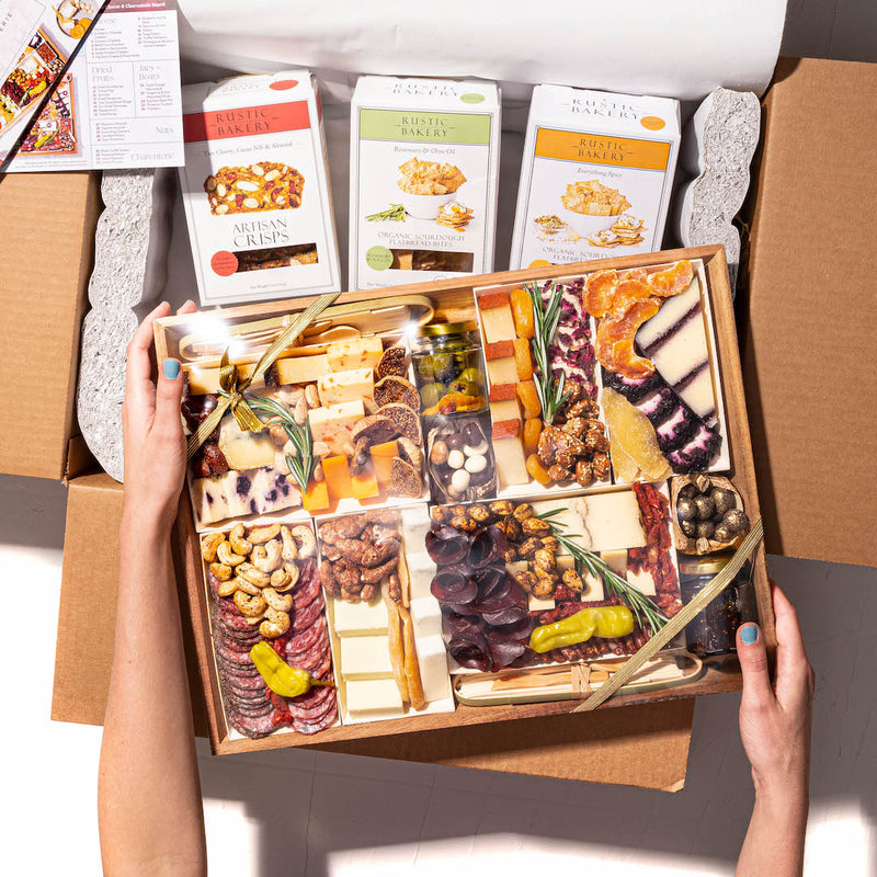 Large gift box with a curated cheese and charcuterie board, paired with artisan crisps and flatbread bites.