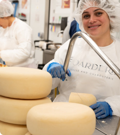 Boarderie chef cutting cheese