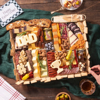 Father's Day charcuterie board featuring assorted cheeses, meats, nuts, dried fruits, crackers, olives, spreads, and cheese cutouts shaped like “DAD,” “#1,” and a trophy, beautifully arranged with a “Happy Father's Day” card.