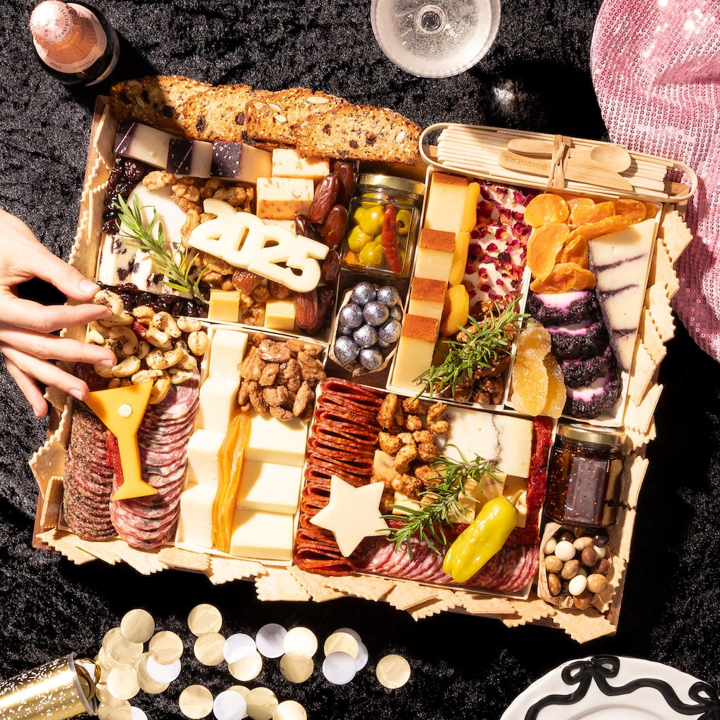 Charcuterie board New Years themed with year, martini and star cut outs. This is a large featuring over 38 ingredients.