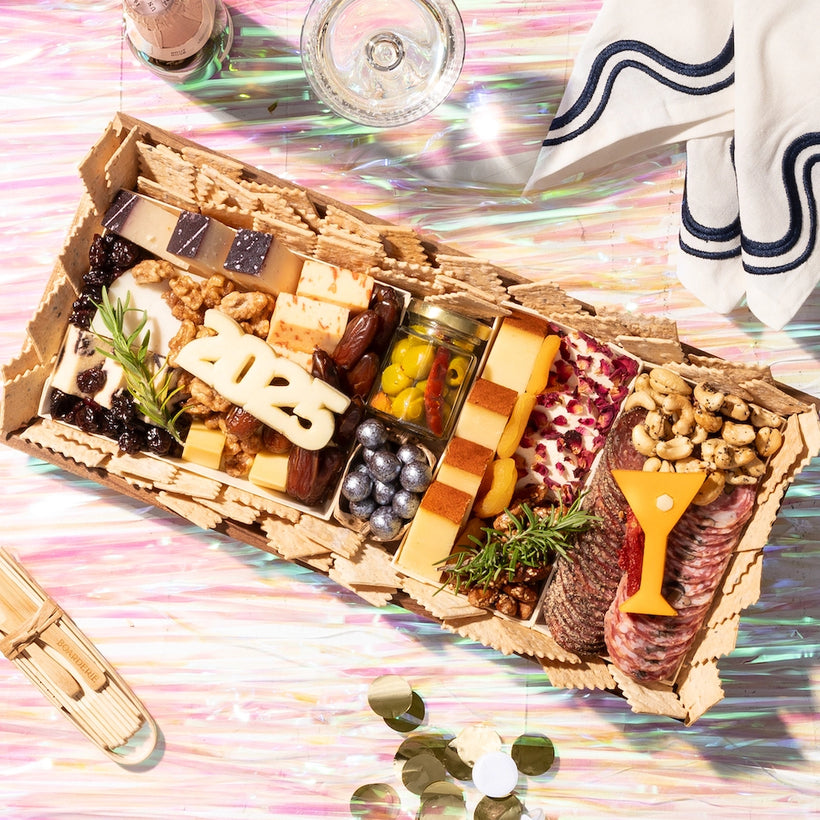 Charcuterie board New Years themed with year and martini cut outs. This is a medium featuring over 20 ingredients.