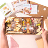 Hands holding an Easter-themed charcuterie box with cheese, meats, pastel candies, and festive egg and bunny shapes.