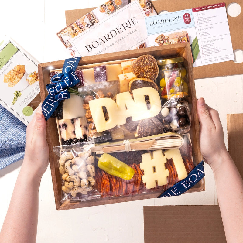 Boarderie Father's Day charcuterie box with "DAD" and "#1" cheese cutouts, nuts, meats, and an assortment of treats.