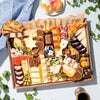 large charcuterie board arranged for a Jewish holiday, featuring assorted cheeses, dried fruits, nuts, crackers, & honeycomb