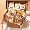 large Charcuterie board delivery box featuring assorted cheeses, meats, nuts, dried fruits, & artisan crackers