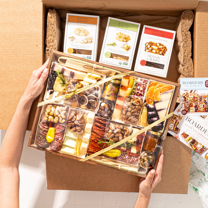 Large gift box with a curated cheese and charcuterie board, paired with artisan crisps and flatbread bites.