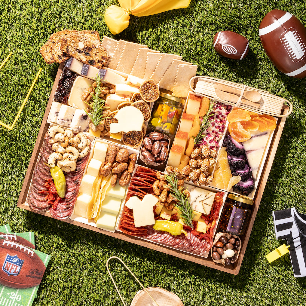 https://boarderie.com/cdn/shop/files/large-football-snack-cheese-charcuterie-board-delivered-nationwide_1600x.jpg?v=1697592528