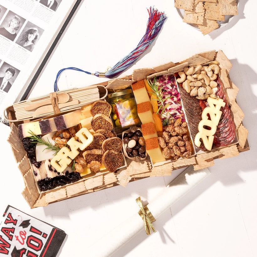 Graduation-themed medium charcuterie board featuring cheese blocks spelling "GRAD" and "2024," surrounded by crackers and assorted snacks.