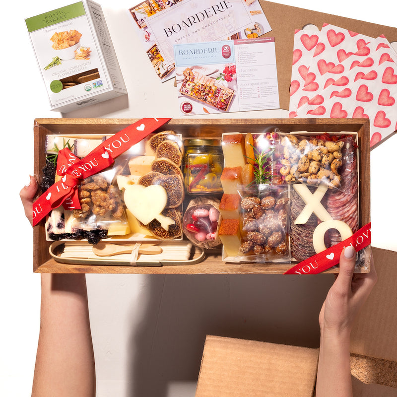 medium Valentine's Day cheese and charcuterie gift box with heart and "XO" shaped cheeses, nuts, figs, cured meats, & a "Love You" ribbon