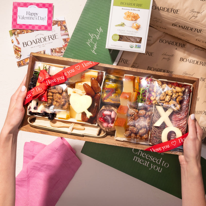 medium Valentine's Day cheese and charcuterie gift box with heart and "XO" shaped cheeses, nuts, figs, cured meats, & a "Love You" ribbon