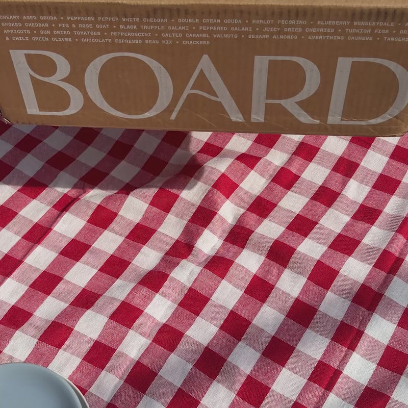 Video showing the box being opened, taking out ice packs that keep the USA cheese & charcuterie board cold during shipping, and pulling out the cheese & charcuterie board itself. 