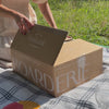 Unboxing medium happy birthday dessert board in a picnic setting