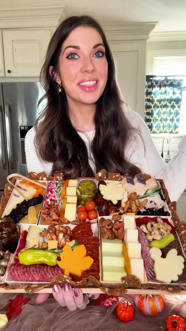 Thanksgiving cheese and charcuterie board being unboxed by girl with brunette hair