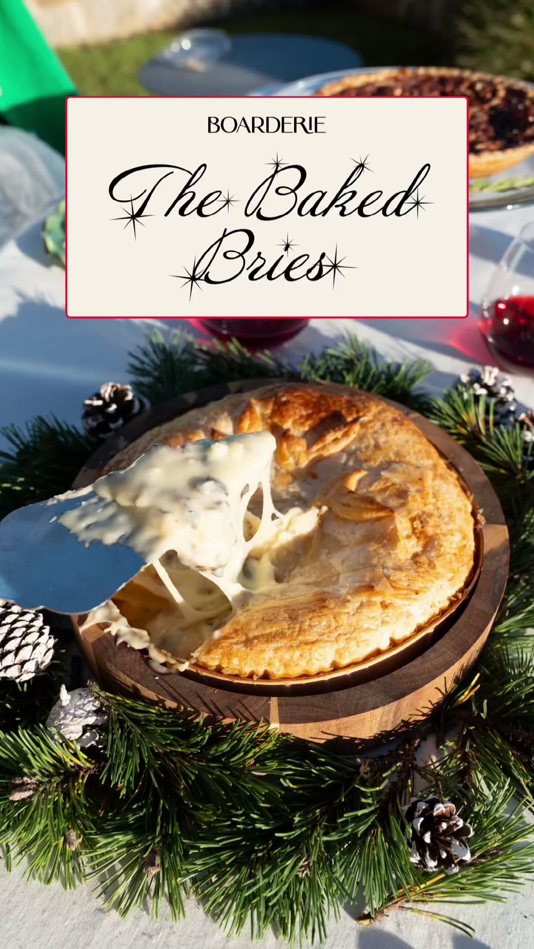 baked brie holiday gift sitting atop a white table with holiday decorations