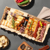 Medium charcuterie tray with assorted cheeses, meats, nuts, crackers, and truffle accents on a dark table setting